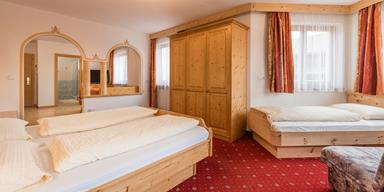 Bedroom of the Family Suite with a double and a single bed
