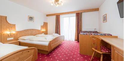 Superior Double Room with three beds and a balcony