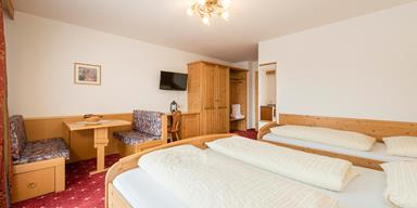 Superior Double Room with three beds and a sitting area