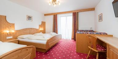 Superior Double Room with three beds and a balcony