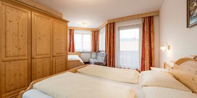 Bedroom of the Family Suite with a double and a single bed