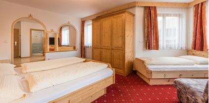 Bedroom of the Family Suite with a double and a single bed