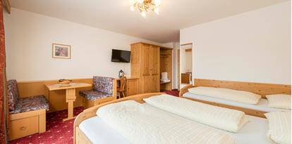 Superior Double Room with three beds and a sitting area