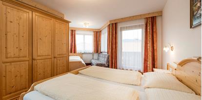 Bedroom of the Family Suite with a double and a single bed