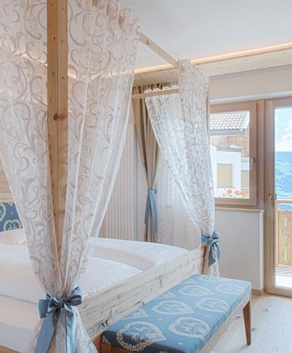 Bedroom with canopy bed and balcony