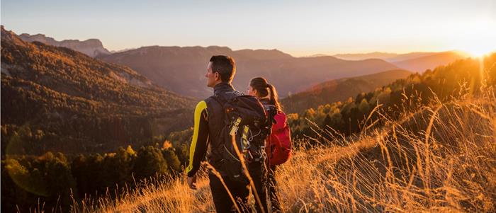Two hikers enjoy the autumn view